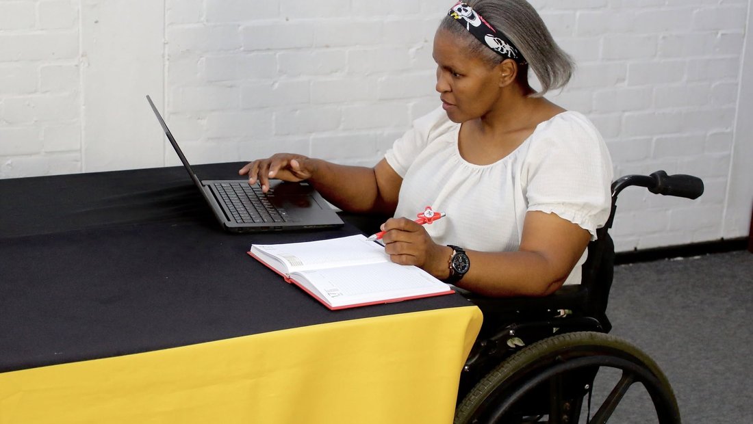 A Cape Town APD staff member working at a branded desk